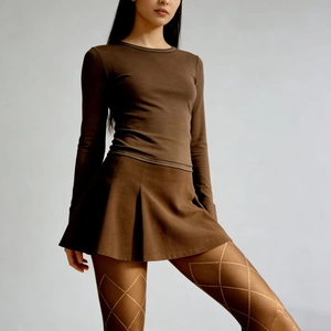 Brown long sleeve top with pleated mini skirt and vintage diamond pattern tights for women