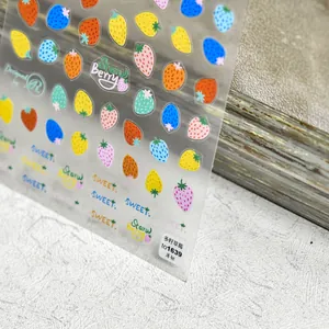 Detailed view of colorful 5D strawberry nail art stickers with sweet fruit patterns