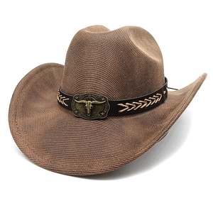 Brown woven western cowboy hat featuring vintage bull head metal buckle and leather band
