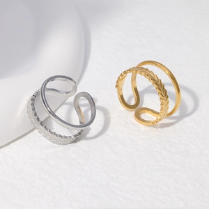 Close-up of double-layered leaf pattern open rings in gold and silver stainless steel