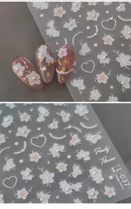 Macro shot of 3D embossed floral nail decals with pearls and butterfly motifs on TL-037