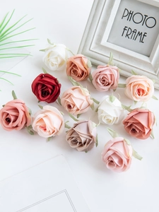 Flat lay of artificial silk roses in white, pink, and red for DIY floral arrangements