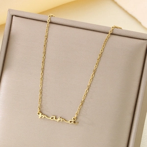 Detail of 18K gold plated mama cursive pendant on a fine stainless steel chain
