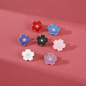 Set of seven colorful cherry blossom enamel pins in various vibrant pastel shades