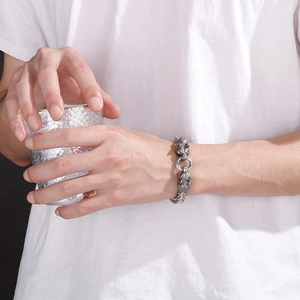 Detail of double lion head link bracelet in vintage frosted stainless steel finish
