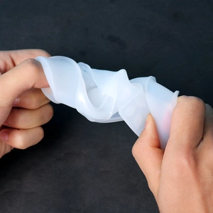 Close-up of flexible translucent silicone mold showing high elasticity and tear resistance