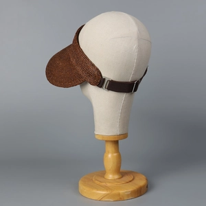 Detail of high-density raffia visor with adjustable elastic band and metal buckle strap