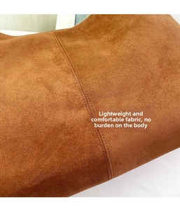 Macro shot of brown matte suede texture and precision stitching on large tote bag