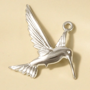 Detailed macro view of a 304 stainless steel hummingbird pendant with textured wings