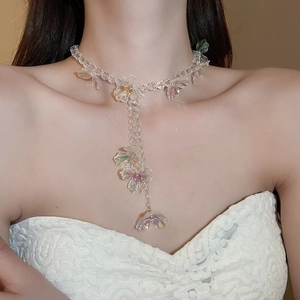 Close-up of elegant flower tassel necklace featuring transparent floral beads on a model