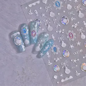 5D embossed ocean themed nail stickers with sea horse and shell designs on blue nails