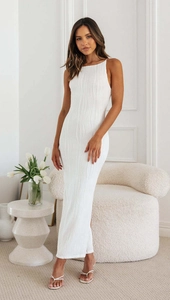 Close-up of white backless bodycon dress with vertical textured wavy pleats and sleeveless design