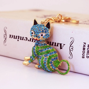 Porte-clés chat en métal doré avec émail vert et cristaux bleus étincelants de luxe