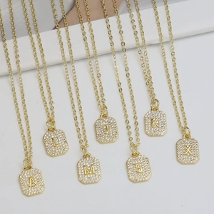 Gold plated square zircon initial necklace with alphabet pendants on white background
