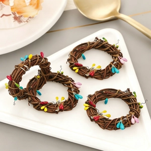 Macro detail of natural rattan napkin rings with colorful beads on a white ceramic plate
