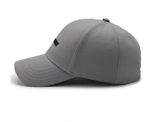 Detail view of dark grey baseball cap showing breathable mesh fabric and fashion label