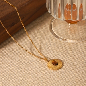 French vintage round textured stainless steel necklace featuring a tiger eye stone pendant