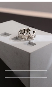 Macro view of vintage brass ring featuring gingerbread man relief and love you engraving