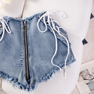 Dettaglio di pantaloncini di denim a vita alta blu scuro con lacci laterali e cerniera