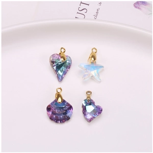 Macro shot of iridescent aurora crystal charms in heart, star and shell shapes