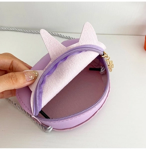 Detailed view of purple cat-ear shoulder bag interior with floral zipper and strap