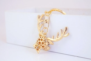 Close-up of a creative gold reindeer head keychain with sparkling crystal details
