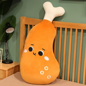 Cute cartoon chicken drumstick plush pillow shown leaning against a wooden headboard