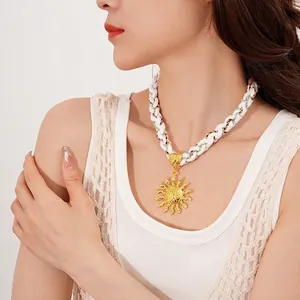 Bohemian sun pendant necklace with colorful braided rope cord for a summer vacation look