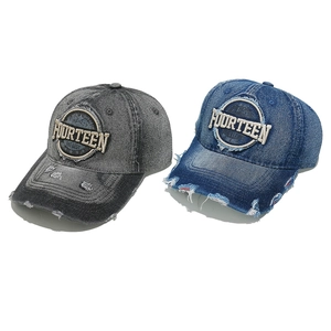 Detailed view of FOURTEEN letter embroidery and distressed denim baseball caps