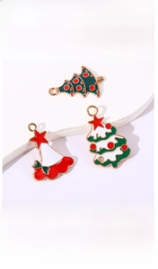 Macro shot of colorful enamel Christmas tree and holiday dress charms on a white stand