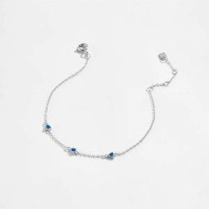 Close-up of S925 sterling silver bracelet featuring three blue triangle zircon stones
