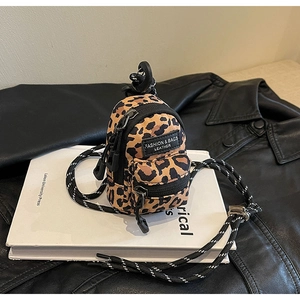 Mini leopard print backpack charm with zipper pockets and a black climbing clip