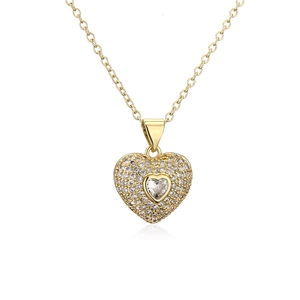 Macro shot of gold plated heart pendant necklace with micro-paved sparkling cubic zirconia