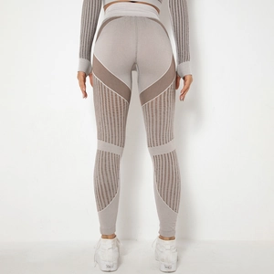 Detail view of seamless taupe yoga leggings featuring breathable mesh and striped texture