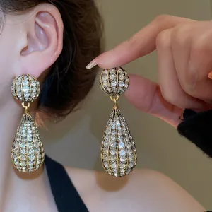Vintage gold-tone water drop earrings with dazzling rhinestones and hollow cage design