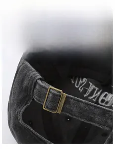 Close-up of adjustable bronze metal buckle on vintage grey washed cotton baseball cap