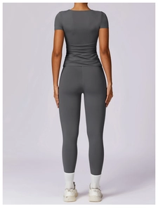 Back view of dark grey slim fit yoga set featuring moisture wicking athletic fabric