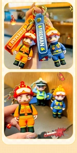 Detail of firefighter cartoon keychain featuring PVC figure and FIREMAN textile strap