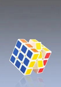 Detail of 3x3 puzzle cube with smooth rounded corners and colorful stickers on white frame