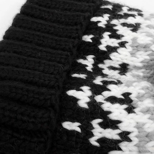 Macro detail of chunky knit texture and geometric pattern on winter beanie hat