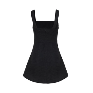 Detail view of the back showing invisible zipper and honeycomb texture on black dress