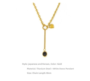 Detail of 48cm gold titanium steel necklace with heart and black zircon stone pendant