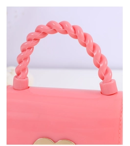 Detailed close-up of the pink jelly bag featuring a unique spiral twisted handle design