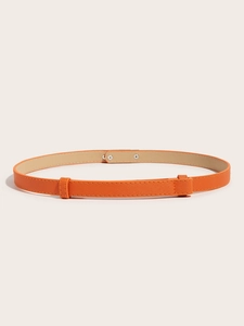 Detail of orange crossgrain leather waist belt featuring a gold-tone metal snap buckle
