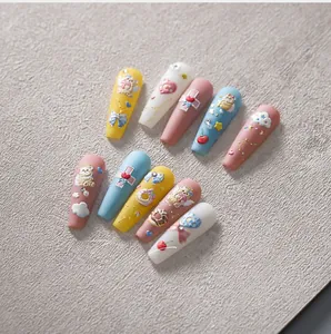 Macro detail of 3D embossed angel bear and macaron matte long trapezoid press-on nails