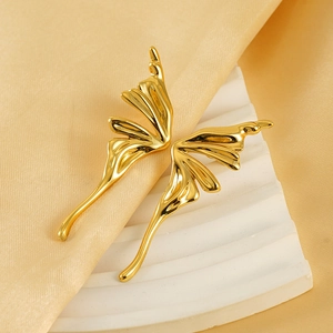Elegant liquid metal butterfly wing earrings in bright gold finish on silk background