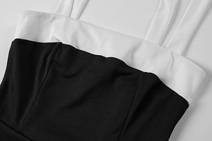 Detail of the black and white contrast neckline and thin shoulder straps on the summer dress