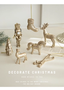 Golden Christmas tree ornaments with champagne glitter finish showing nutcracker and reindeer