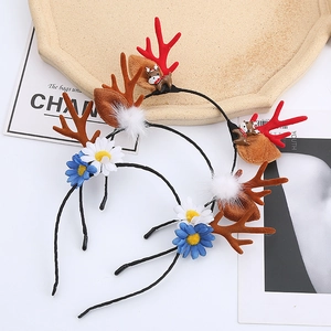 Detailed view of Christmas reindeer antlers headband with brown plush ears and floral decor