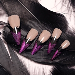 Almond shaped press-on nails with purple glitter and black drip design on dark feathers